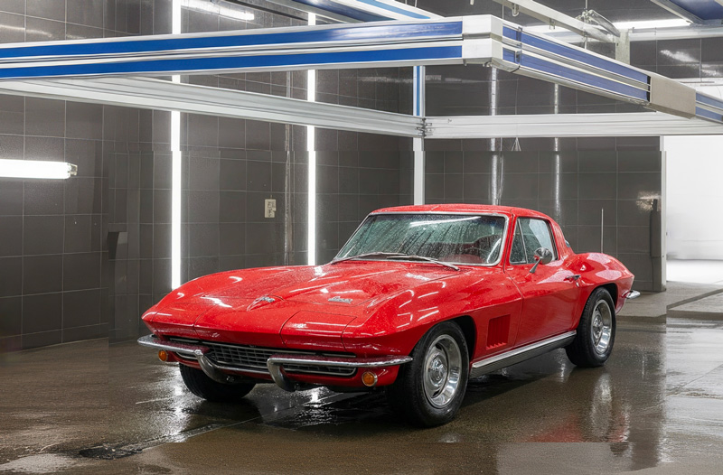 photo of a red classic car being washed by a Hercules car wash system