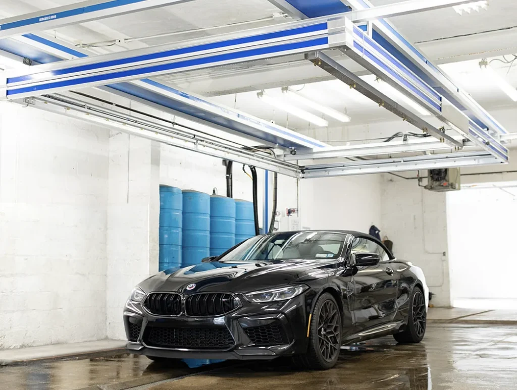 Black BMW car under a Hercules 6000 vehicle wash system
