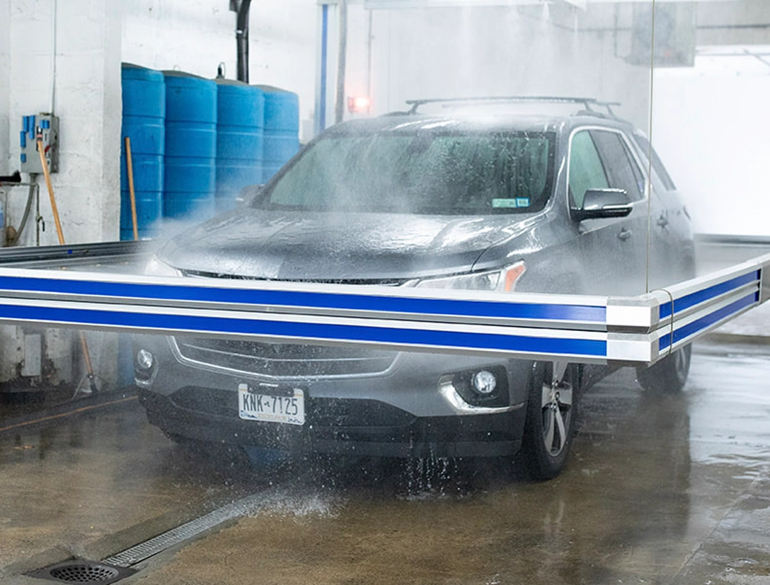 gray SUV being washed by a Hercules car wash system